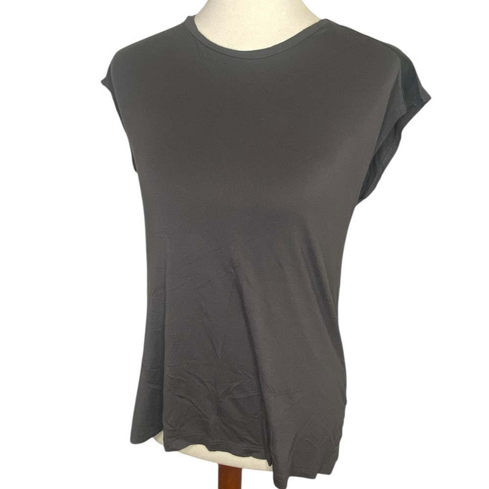 The limited top with faux leather accents